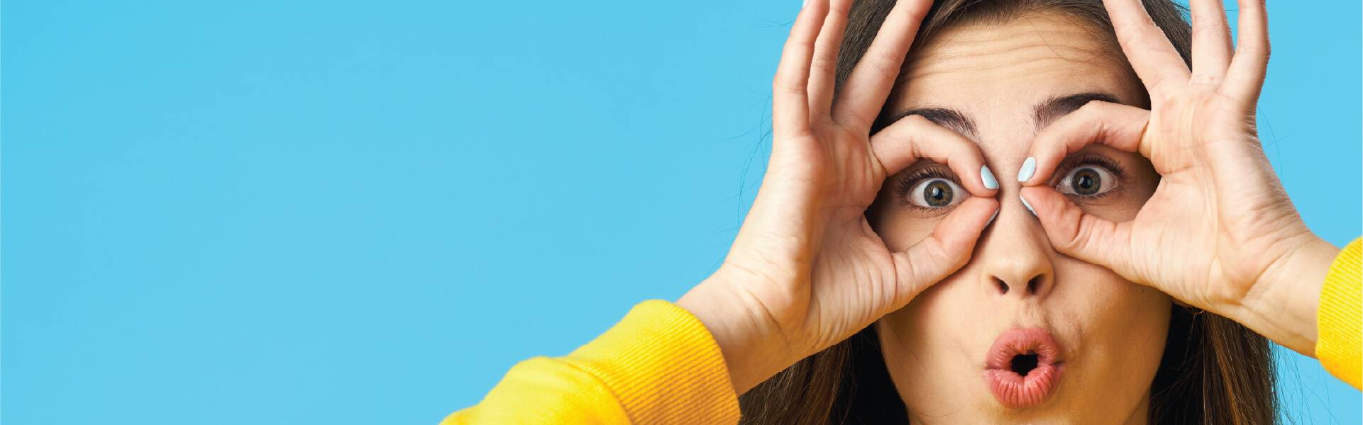 Woman peering through her hands – free policy health check from Dragonfly Crowd